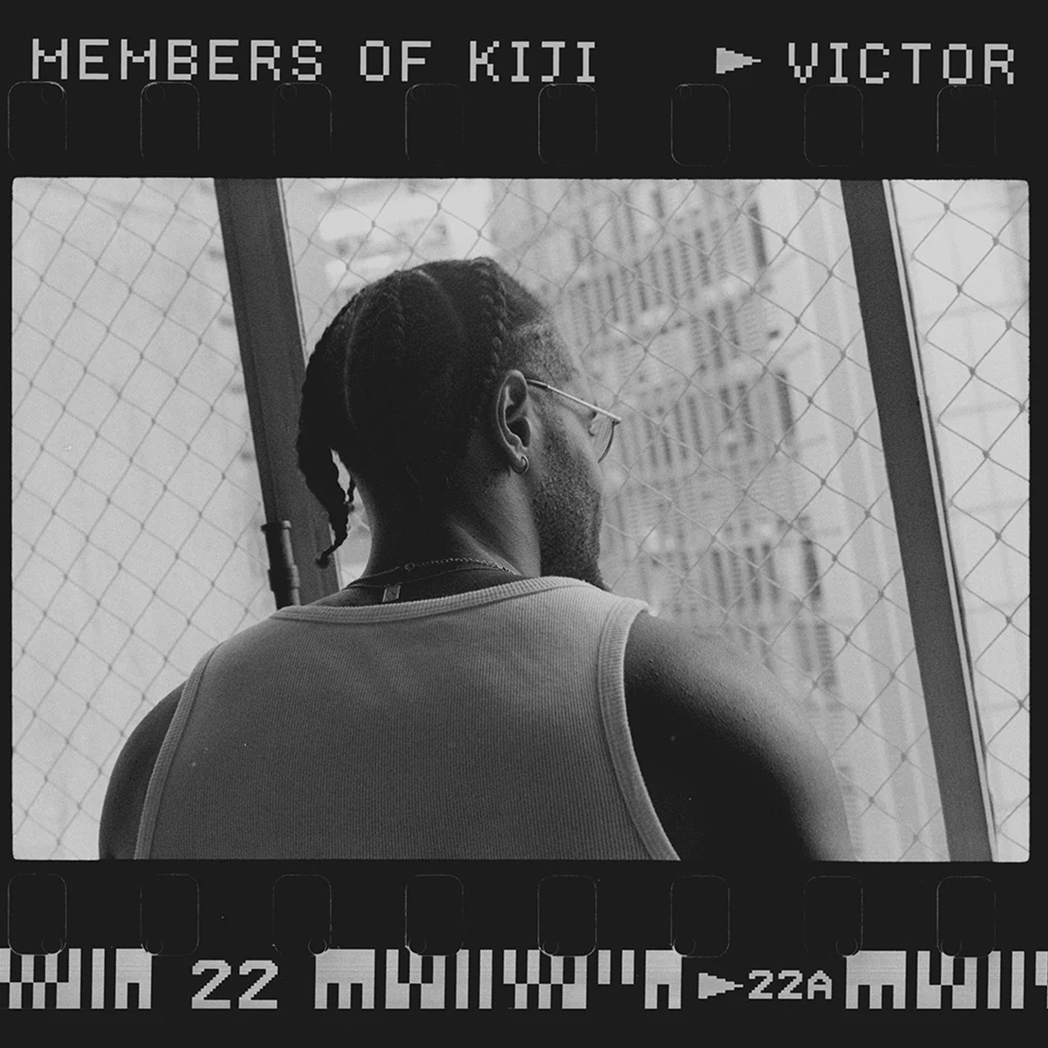 Banner contendo uma foto de um de nossos clientes usando a regata Tank-Top Kiji Off-White, na foto, o modelo usa tranças e óculos olhando pela janela do seu apartamento